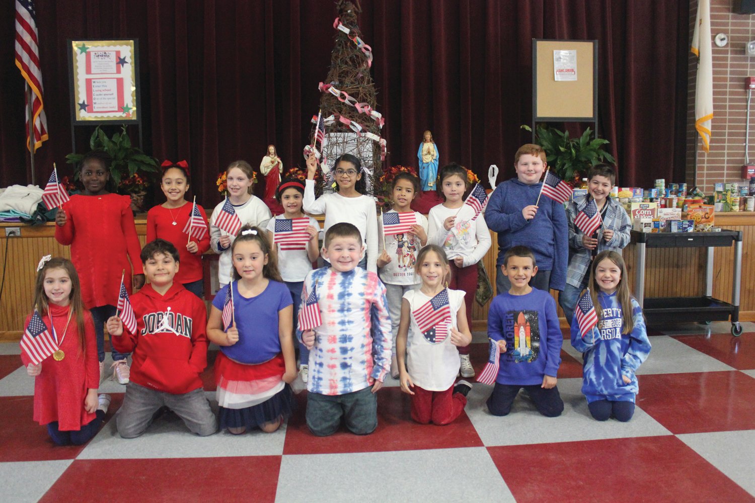 PATRIOTIC PRAYERS: St. Rocco School held its Veterans Day Prayer Service Wednesday, Nov. 9 at St. Rocco Church, 931 Atwood Ave., Johnston. Students from St. Rocco School read poems that they wrote, carried photos of loved ones, sang patriotic songs and prayed for all veterans.  Also, the school held a “Dress Down Day” for "Operation Christmas Stocking" where students dressed in red, white and blue, along with donating a dollar for the cause. Proceeds will go toward filling stockings for soldiers in the 43rd MP Brigade.